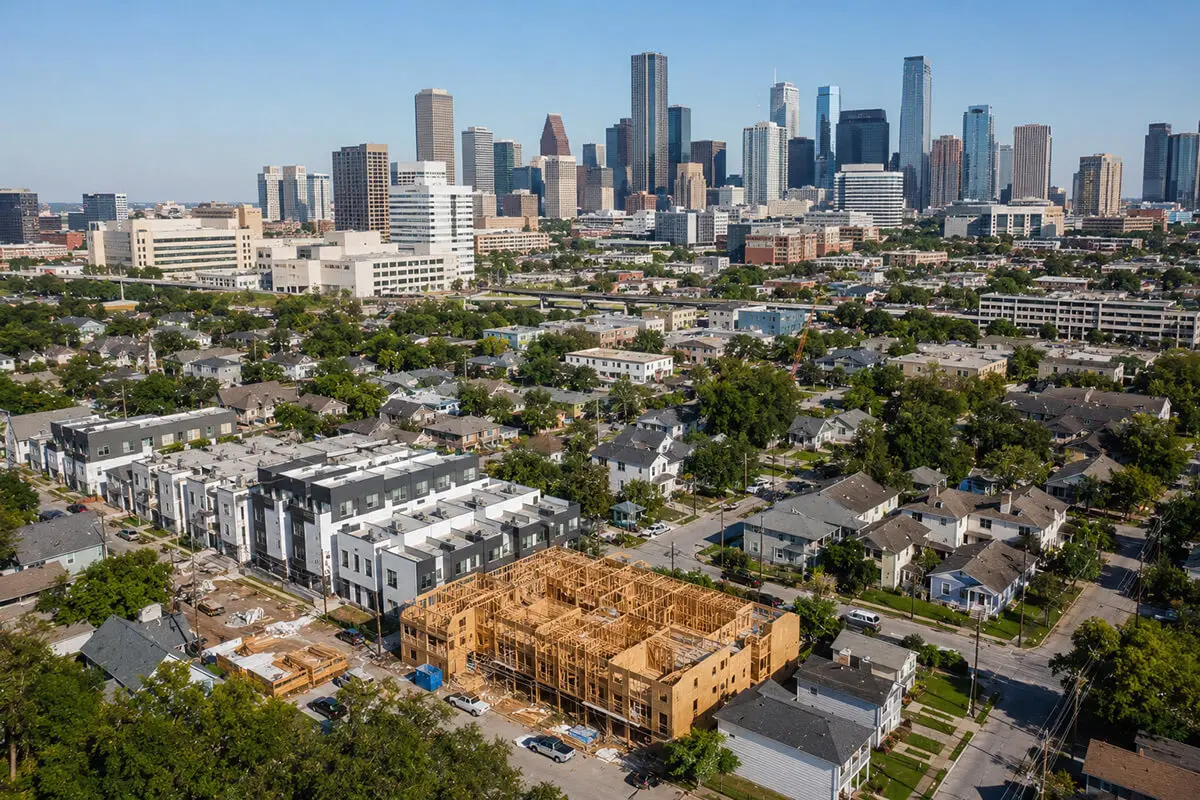 Aerial view of Houston Proper featuring new townhome development, established neighborhoods, and the downtown skyline