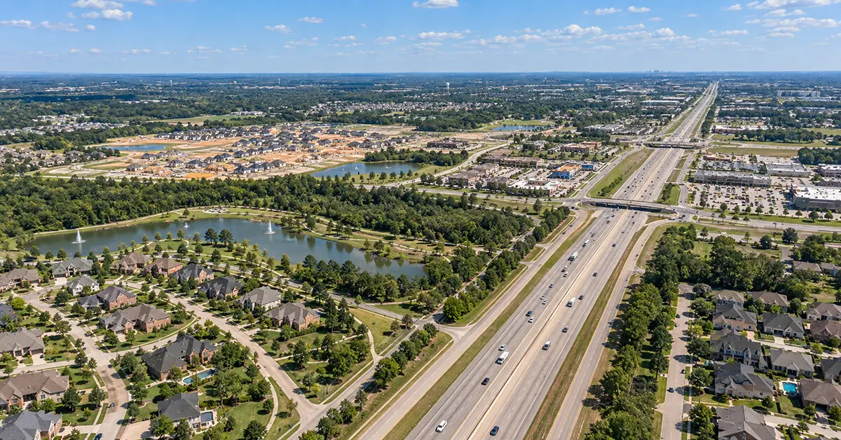 Aerial view of Tomball, TX neighborhoods, new development, lakes, and major highway corridor